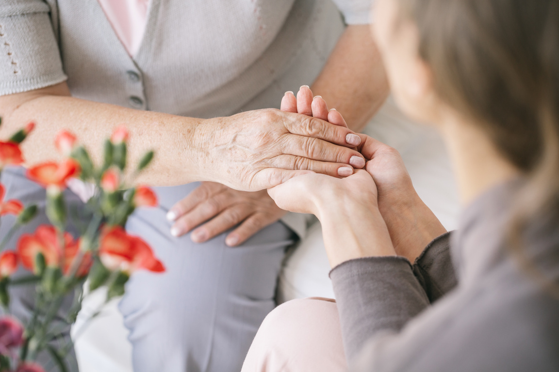 Caretaker giving her hand